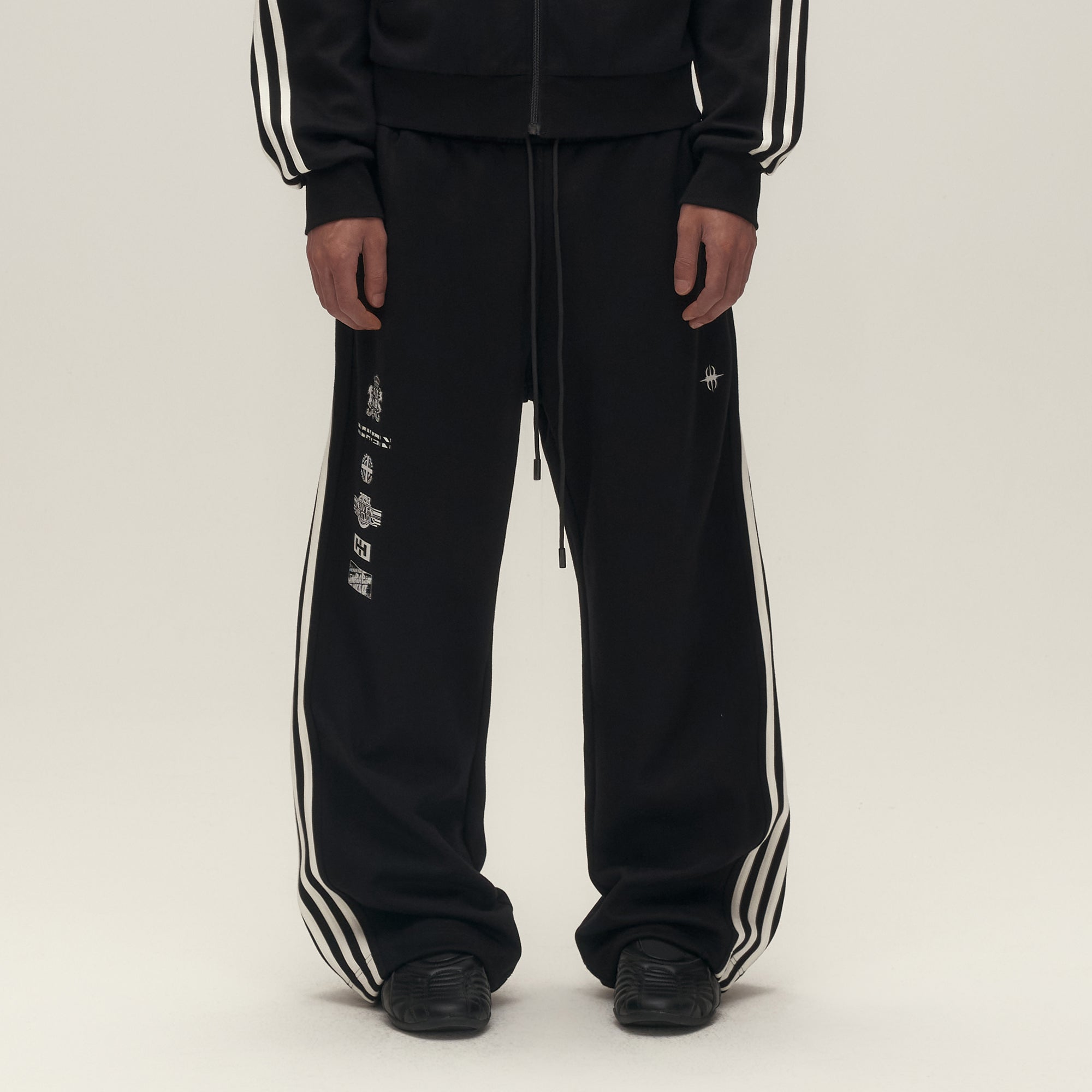 SAVAGEGROWTHWORLD Back-Arc Striped Graphic Track Pants