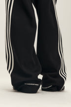 SAVAGEGROWTHWORLD Back-Arc Striped Graphic Track Pants